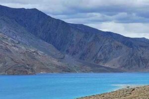 Pangong Lake, a mesmerizing blue lake surrounded by rugged mountains in Ladakh