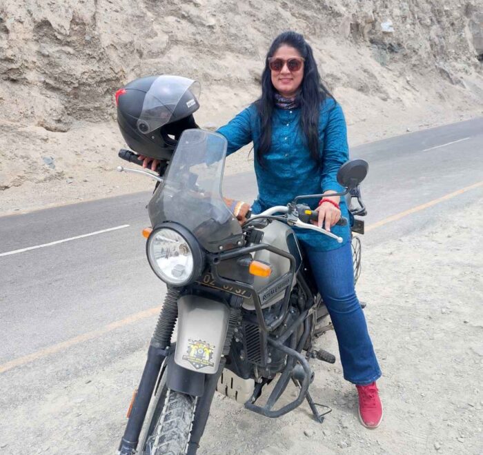 Courageous female rider conquering Ladakh's majestic landscapes.